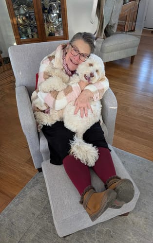 Customer relaxing in a lounge chair while wearing maroon Everstride™ Wide Compression Socks.
